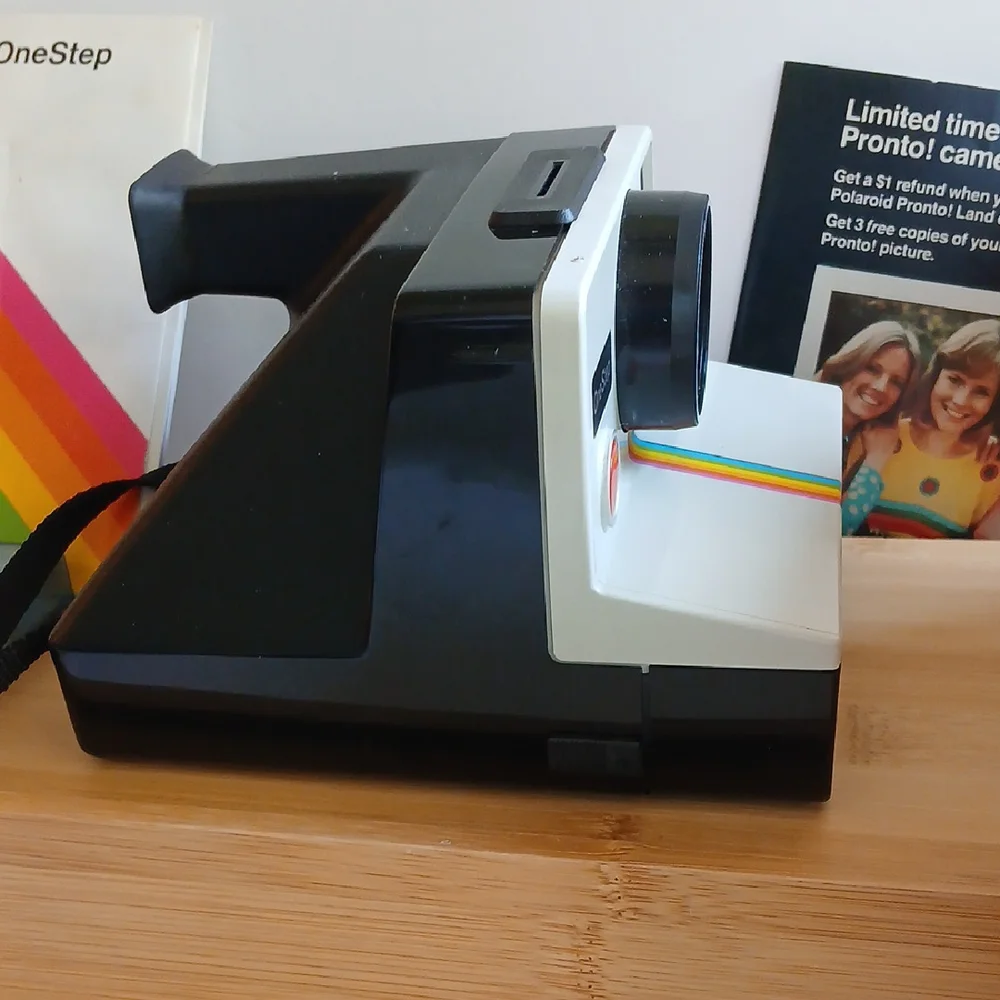 Vintage Polaroid Land One Step Instant Film Camera with Iconic Rainbow Design